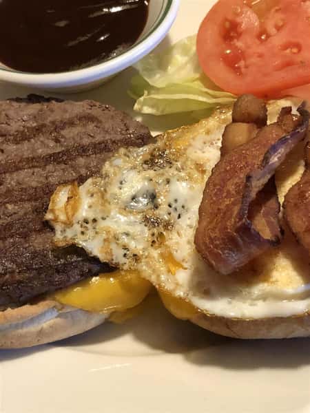 Texas Burger on a plate with bacon and an egg