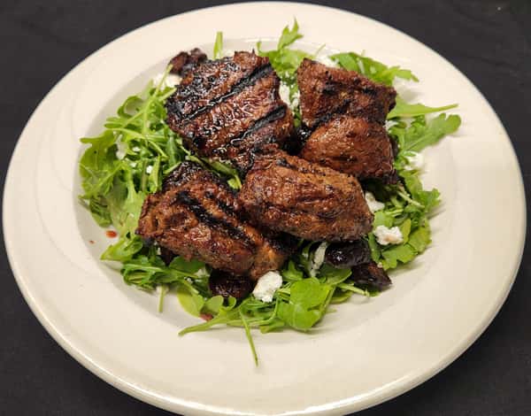 The third image displays glazed chicken wings garnished with sesame seeds and scallions, plated over fresh greens for a bold and flavorful appetizer.
