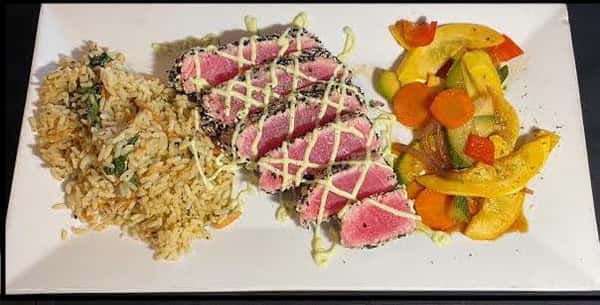 The first image features sliced seared tuna served over rice with a drizzle of creamy sauce, accompanied by colorful roasted vegetables for a fresh and vibrant presentation.