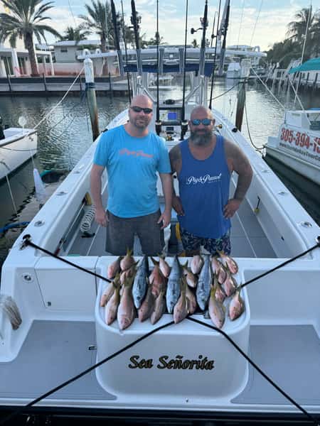 Mike with employee and fish