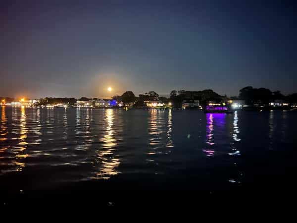 nighttime view of water with boats and lights