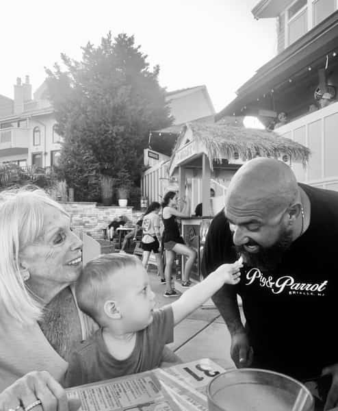 Young customer feeding Mike a fry
