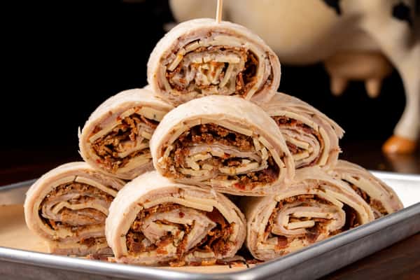 A platter of sandwich wraps for a catered event