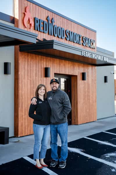Redwood Smoke Shack owners standing in front of the Suffolk location