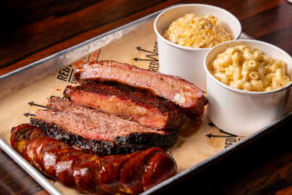 Smoked sausage and ribs served with a side of mac and cheese and bananamisu