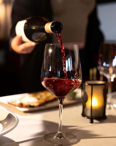 Wine being poured into a glass