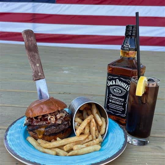 jack daniel burger with fries and glass of whiskey