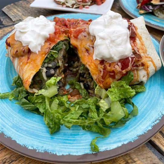 large burrito with rice, black beans, lettuce, cheese and sour cream