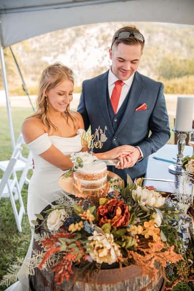 bride and groom cutting their wedding cake