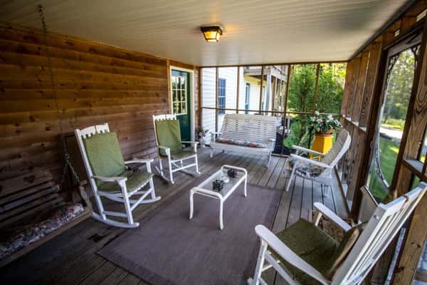 Back porch with white rocking chairs