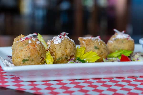 Crawfish Beignets. Seasoned crawfish croquettes deep-fried & sprinkled with cayenne powdered sugar served with Cajun remoulade