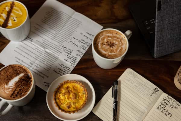 table with journals and lattes