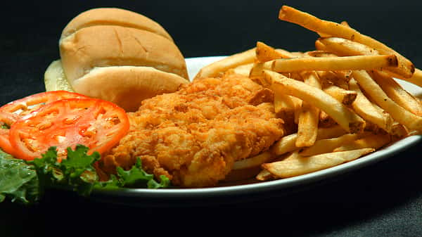 Fried chicken with fries and bread on the side