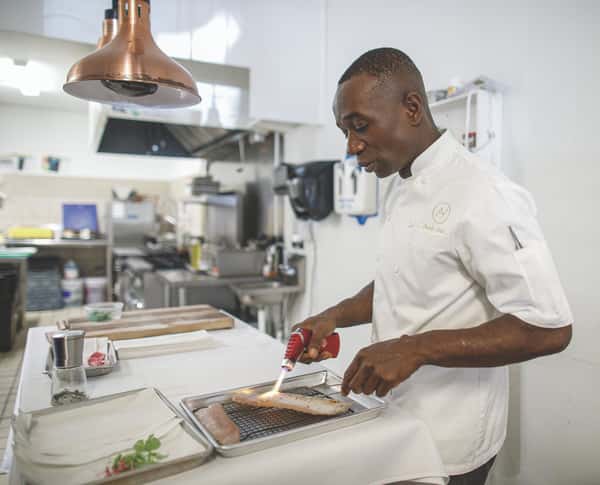 Chef Hyde using a kitchen torch on fresh fish