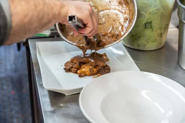 chef placing food onto plate