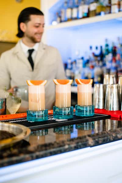 row of cocktails with orange slices