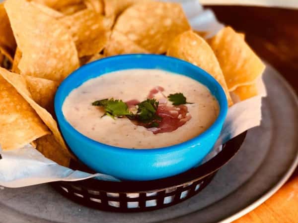 Bowl of queso dip with tortilla chips