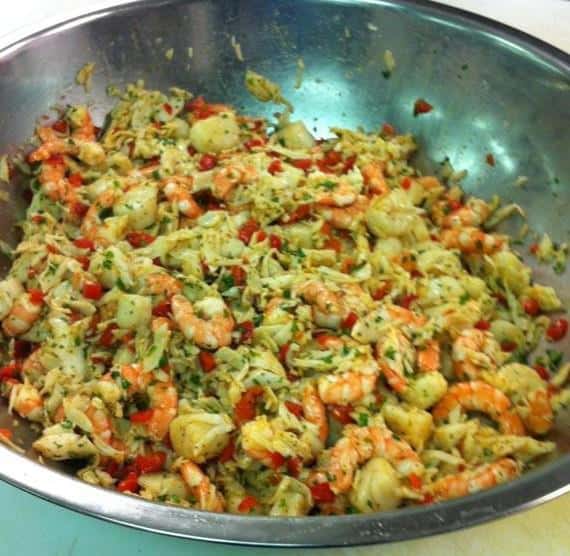 bowl of cooked shrimp, vegetables and herbs