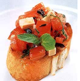 bread topped with sliced tomatoes and basil