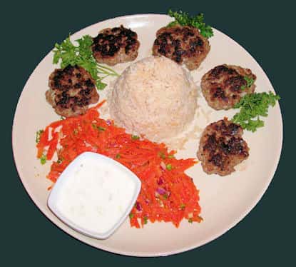 small crab cakes with rice on a plate