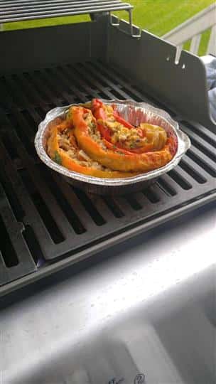 baked stuffed chilis with meat and cheese on a grill