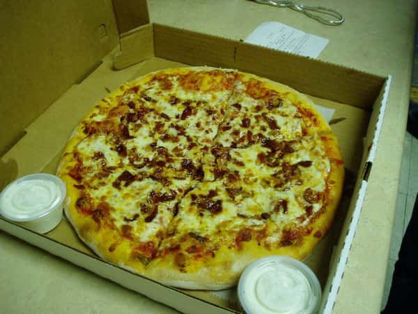 pizza in a box topped with sausage and cheese. Served with ranch dressing.