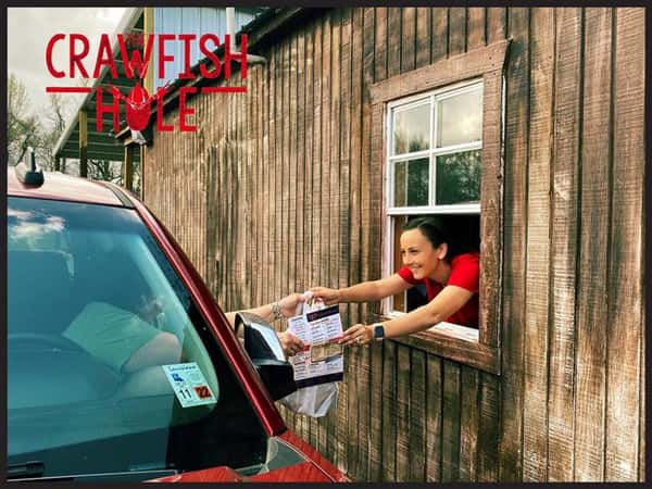 staff passing food to a customer in a car