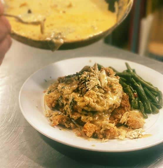 Crawfish Hole Catfish: fried catfish filets on a bed of white rice topped with crawfish etouffee