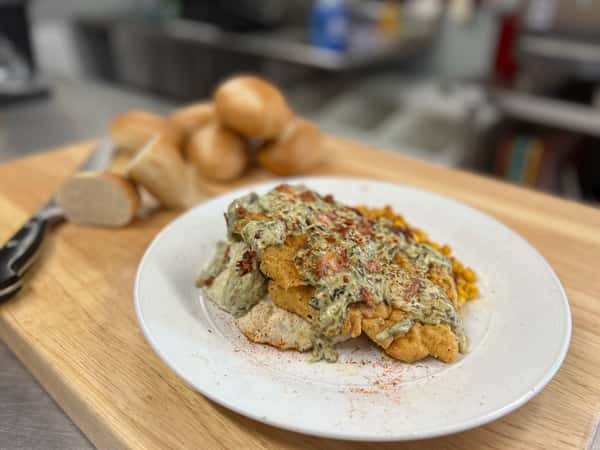 Crawfish Hole Catfish fried catfish filets on a bed of white rice topped with crawfish etouffee