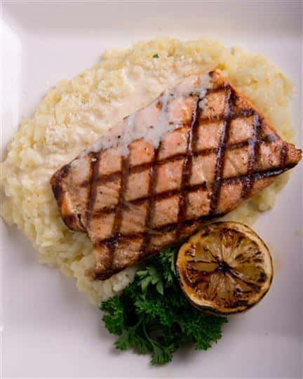 grilled salmon over a bed of rice