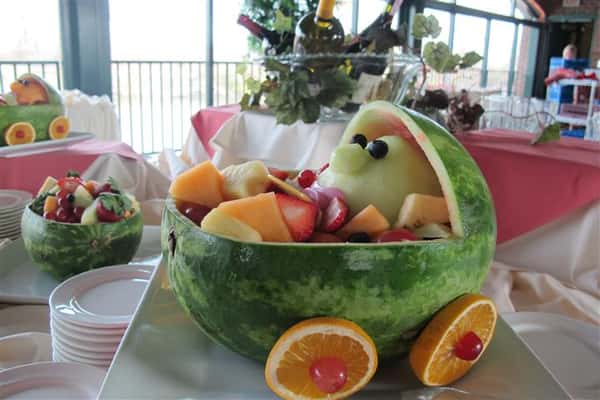 table display of a fruit basket filled with smaller fruit
