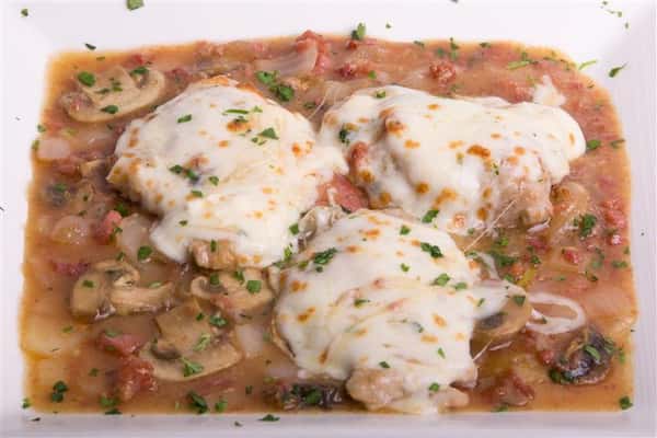 three chicken cutlets with cheese and mushroom sauce