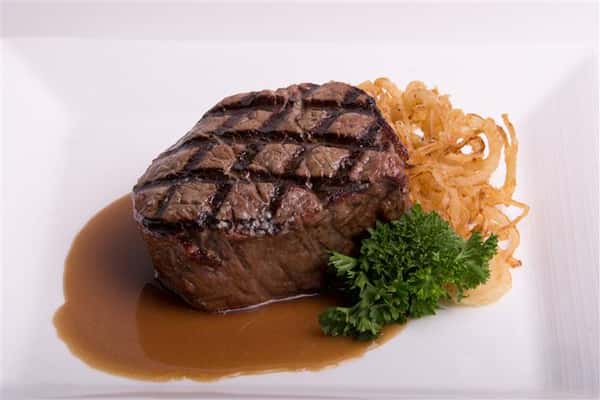 steak with gravy and cooked onions