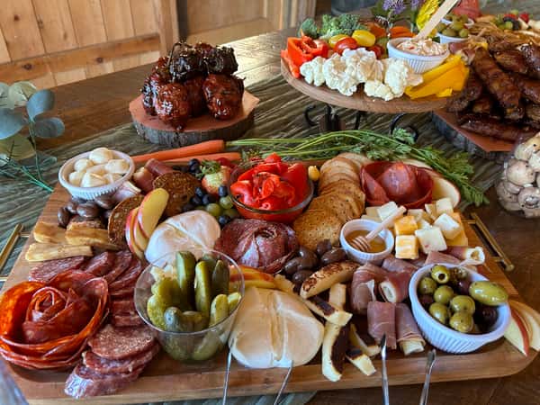 Three charcuterie boards on a wooden table