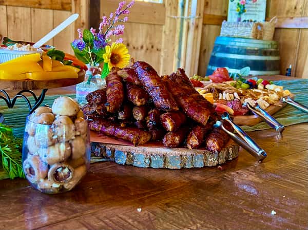 Wooden trunk plate piled with bbq ribs on wooden table