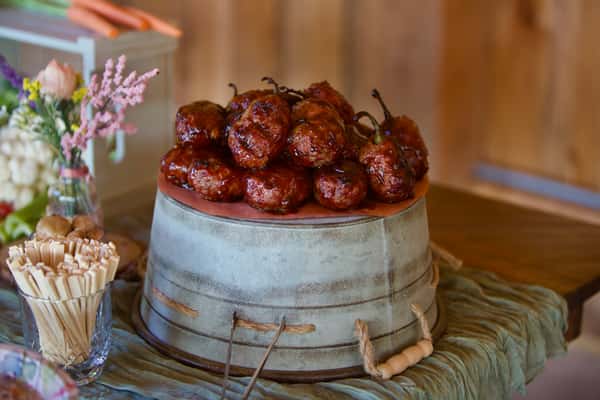Meatball on an upside down tin tub on a wooden table