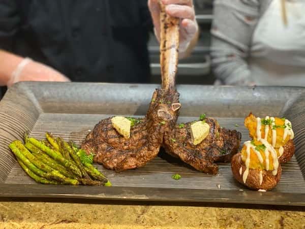 two lamb chops with asparagus on the side