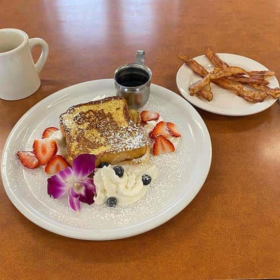 french toast with mug of coffee and side of bacon