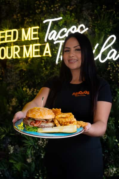 Waitress holding a plate with burger and fries