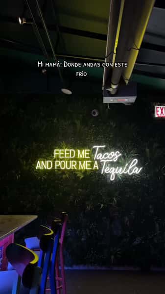 Neon sign that says Feed Me Tacos and Pour Me A Tequila