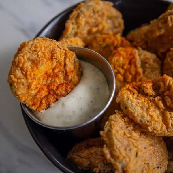 Fried green tomatoes served with a side of dipping sauce