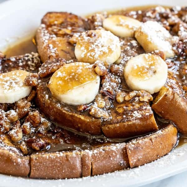 French toast topped with caramelized bananas and pecans