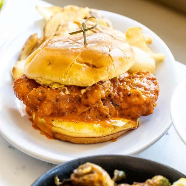 Spicy fried chicken sandwich with pickles on a toasted bun