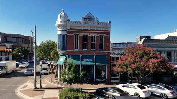 Exterior of a historic red brick corner building with a turret in downtown Georgetown