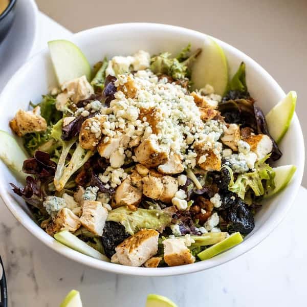Salad with mixed greens, blue cheese crumbles, nuts and sliced green apple
