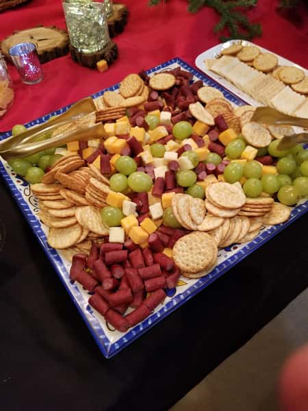 Assortment of Grapes, cheese, and crackers in a tray