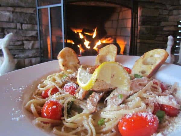 Landing Shrimp Pasta - Sauteed Jumbo Shrimp and our house-made parmesan cream sauce, tossed with linguine. Garnished with diced scallions, tomato and parmesan cheese.