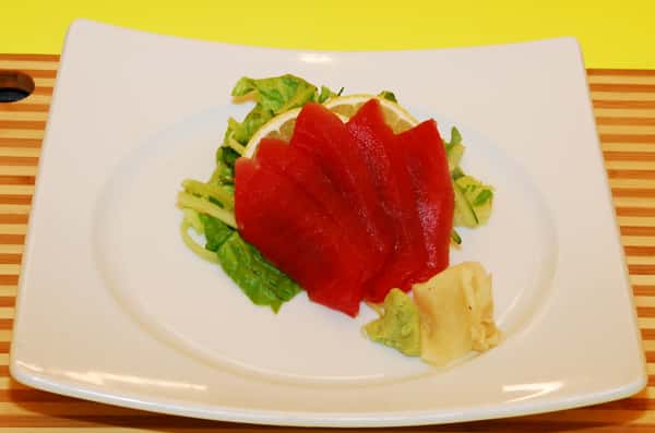 Fresh tuna sashimi served over a bed of greens.