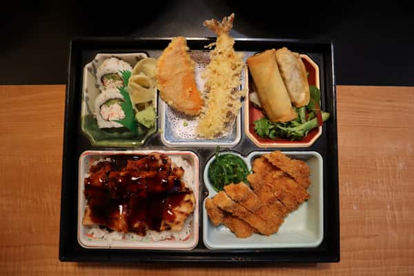 Bento box with sushi, tempura, and teriyaki chicken.