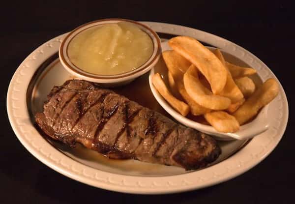 New York Cut Sirloin Steak served with fries and a side of sauce
